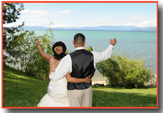 Newlyweds extend champagne glasses to the lake