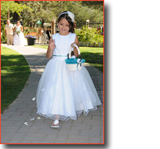 Flower girl walks the aisle dropping flower petals