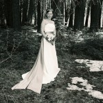 Bride poses in the forest where her wedding took place