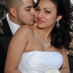 Groom kisses the cheek of his new wife