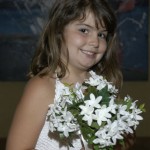 A smiling flower girl with her flowers