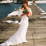 Bride stands on the pier prior to the ceremony