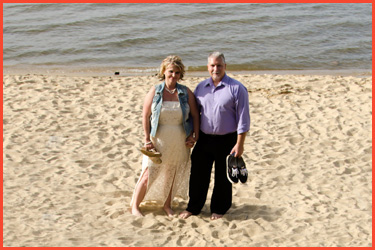 Bride with Groom barefoot on beach